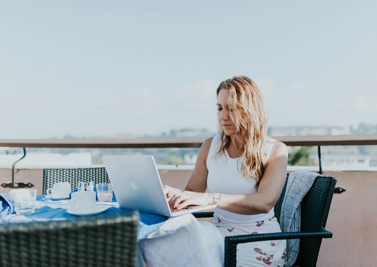 Digital nomad working remotely on a laptop