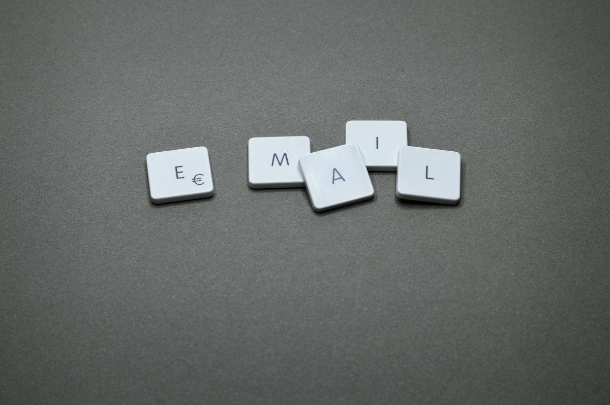 Wooden letter tiles spelling out email on a desk