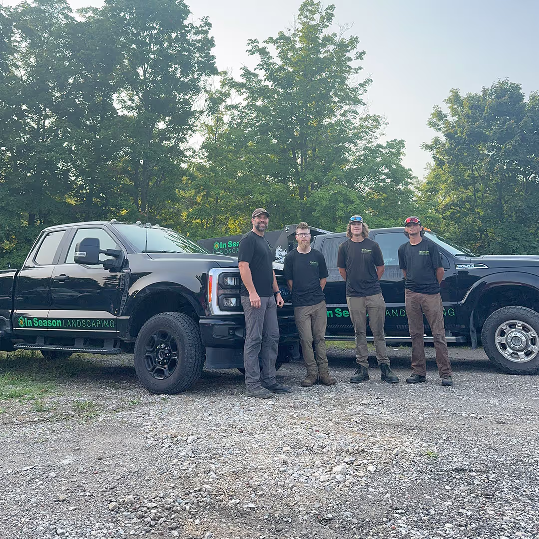 In Season Landscaping team in front of company vehicles