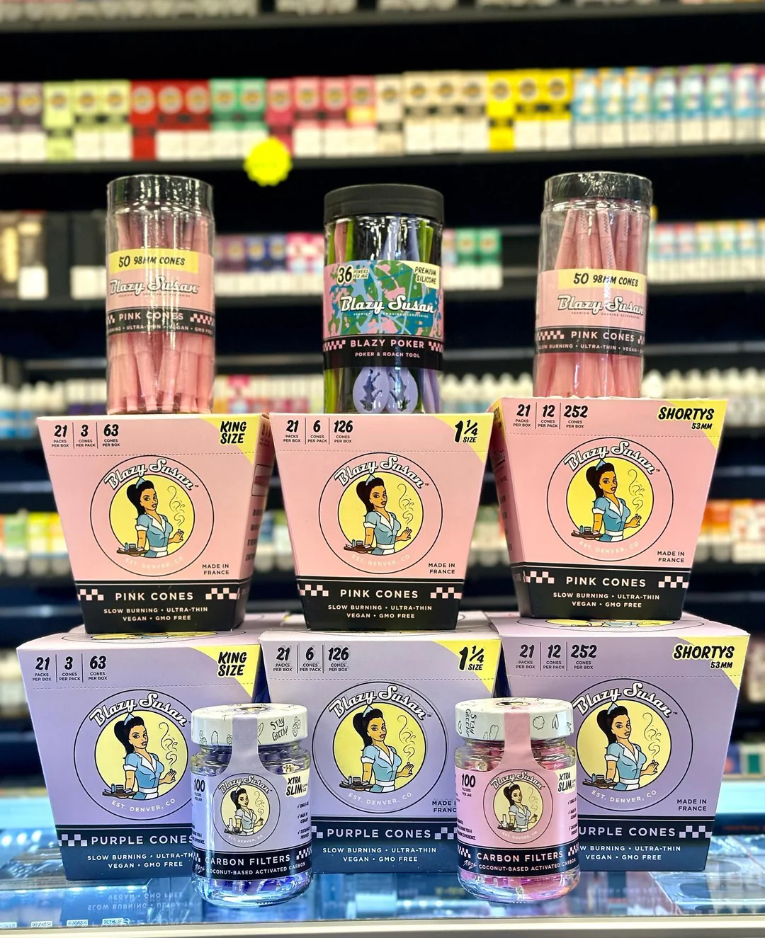 Various Blazy Susan branded pink and purple rolling cones and carbon filters arranged on display.