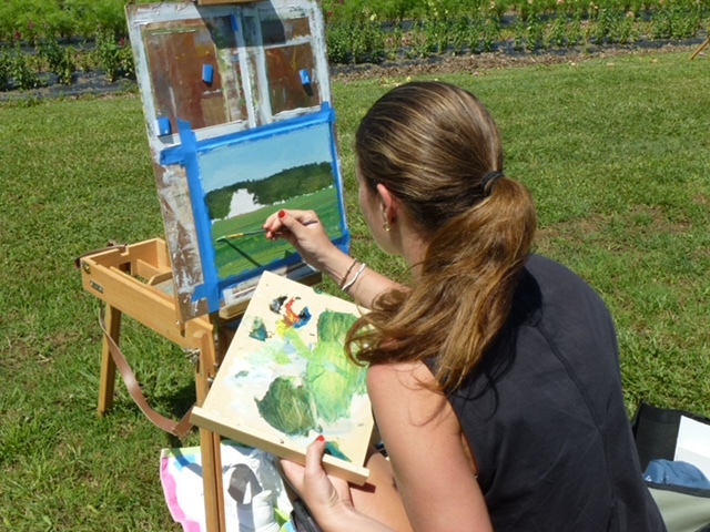 Lara painting outdoors at an easel