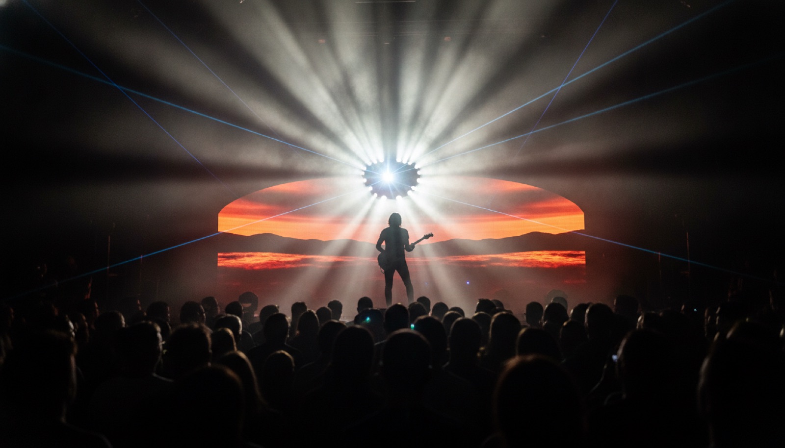 Electric guitarist performing under dramatic stage lasers and spotlights, Napa Valley