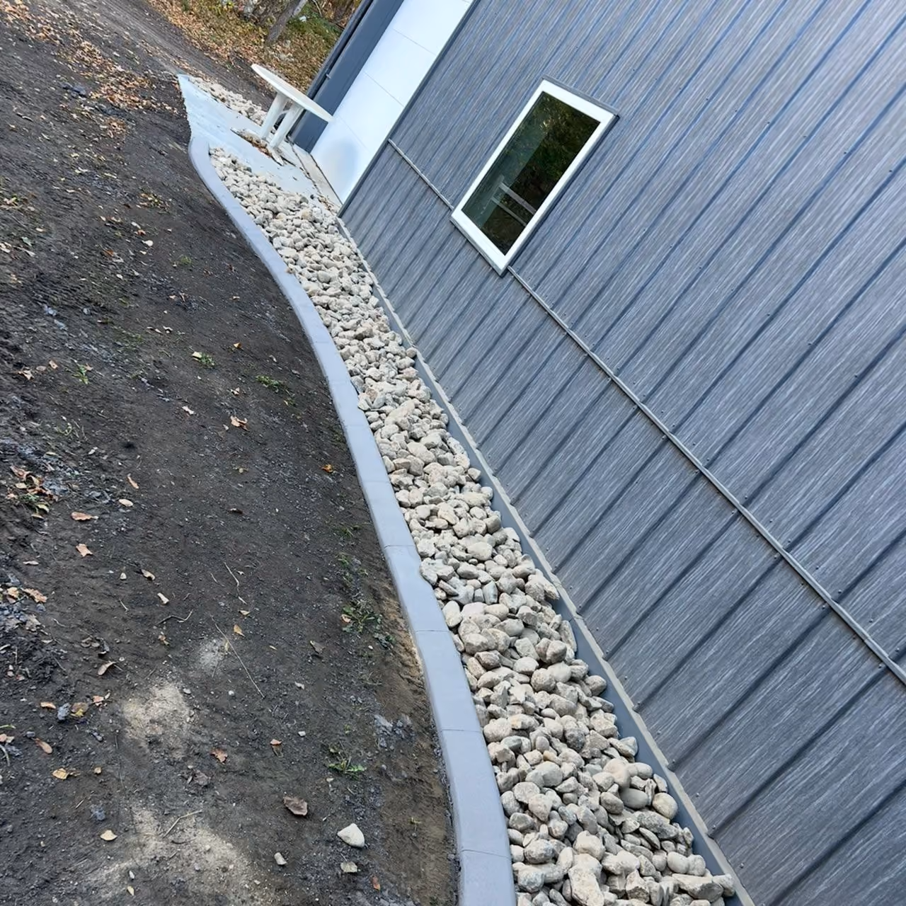 Decorative stone installation by Musolf Property Maintenance for clean, low maintenance landscape beds in Detroit Lakes Minnesota near me
