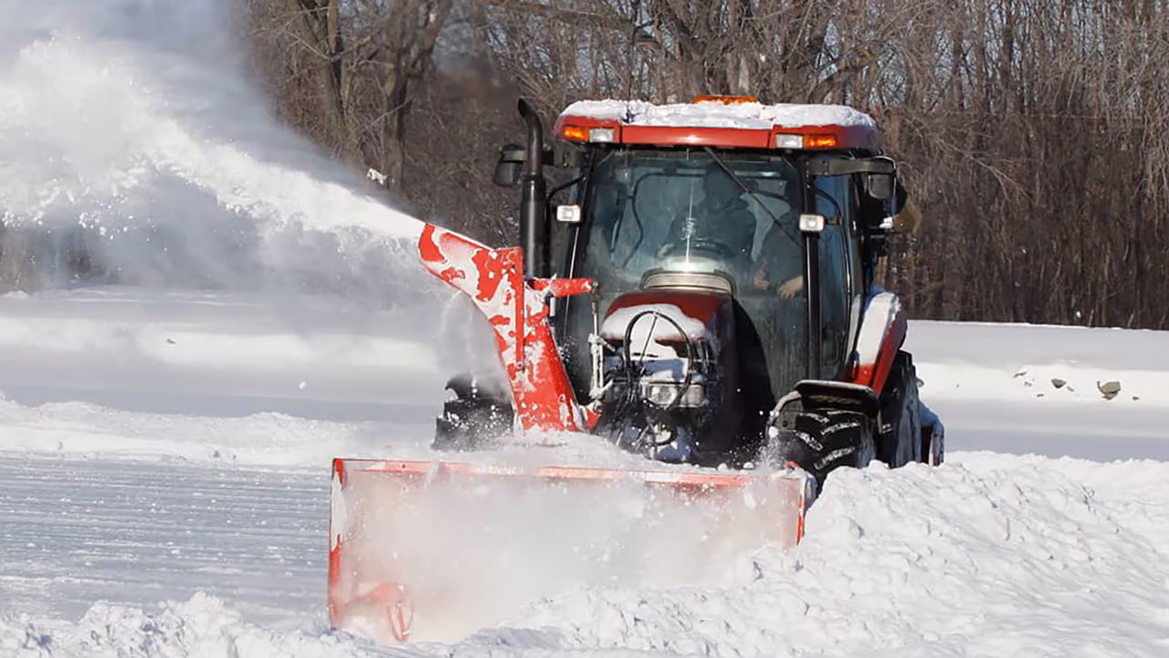 Residential snow removal by Musolf Property Maintenance using tractor mounted snow blowers in Detroit Lakes Minnesota