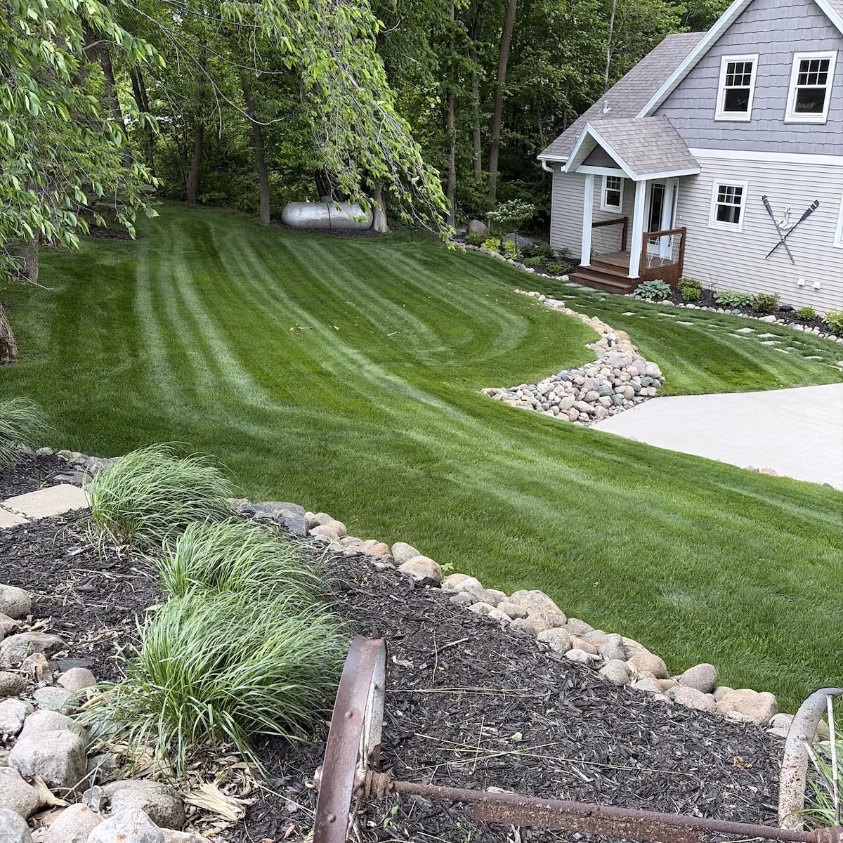 Freshly mowed green lawn with clean edges and professional finish