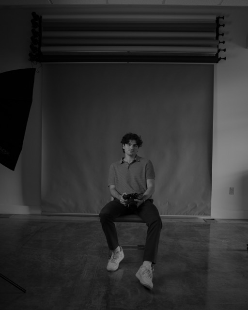 Leo Baralt seated in the studio against a seamless backdrop