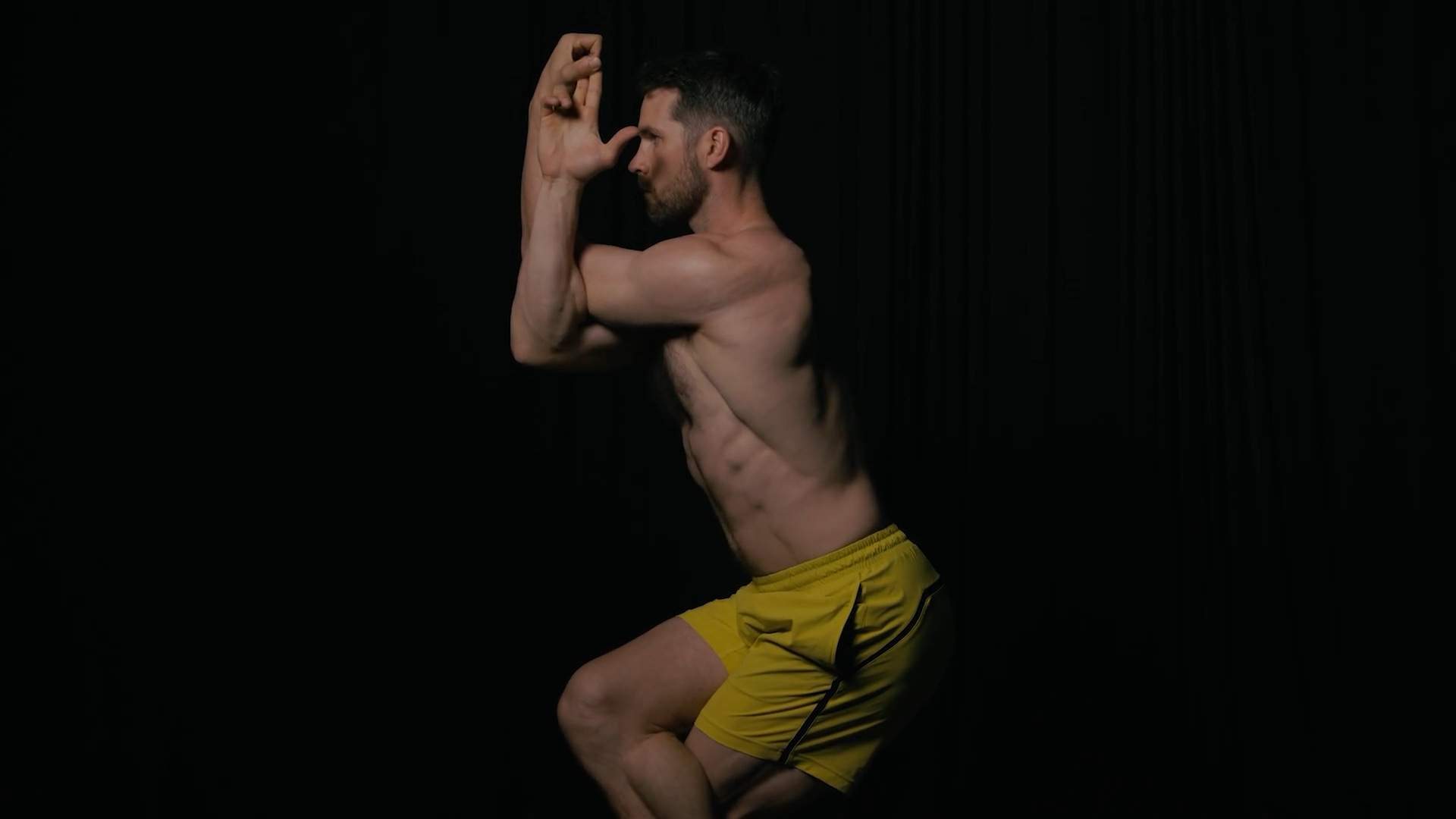 Dean Pohlman holding a balance pose, shot against black for the founder story