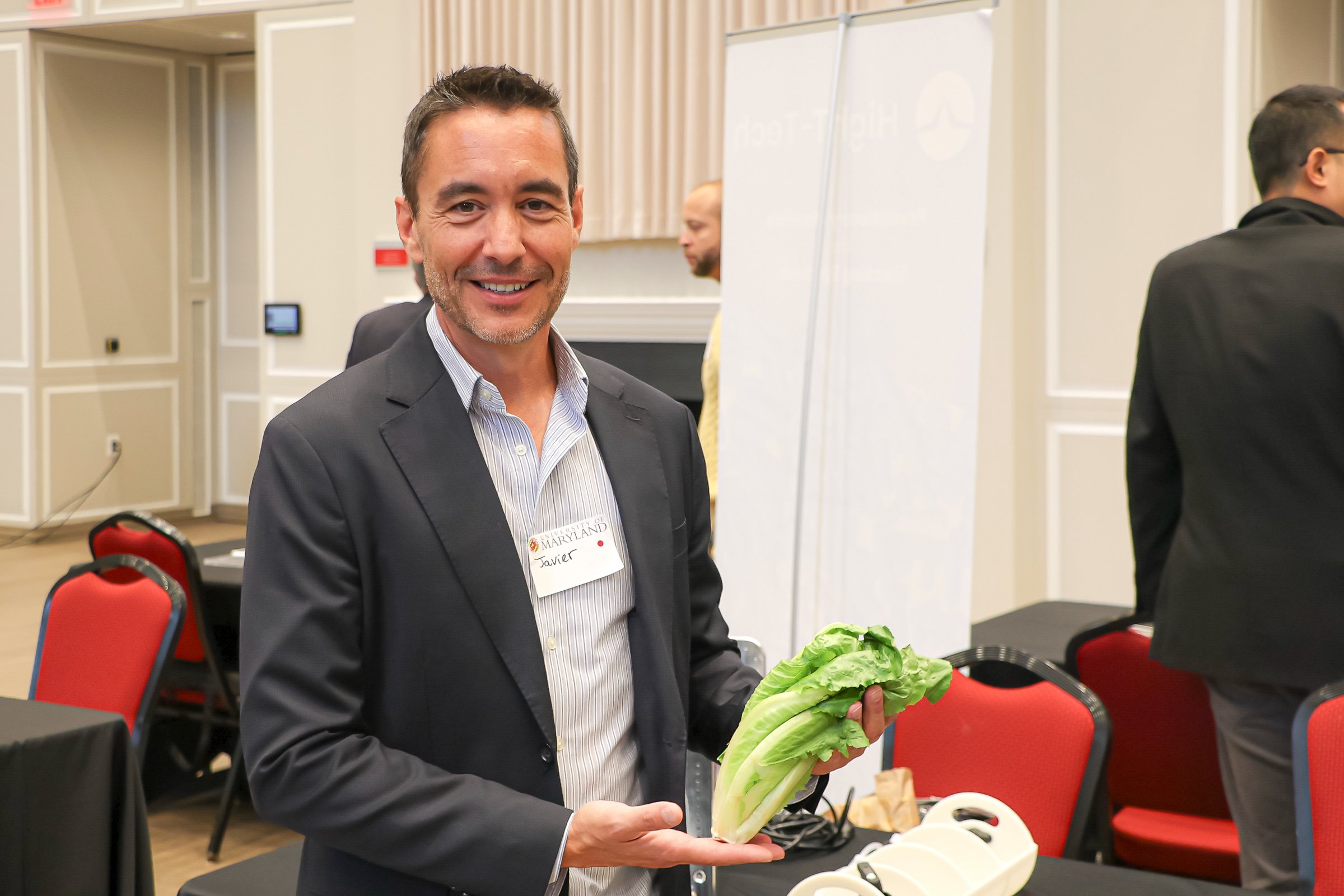 A HighT-Tech founder showing produce grown with their technology