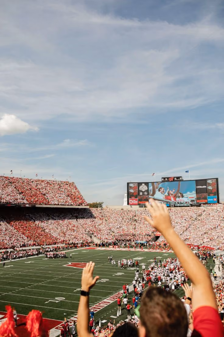 Fans cheering in a packed Camp Randall Stadium on game day