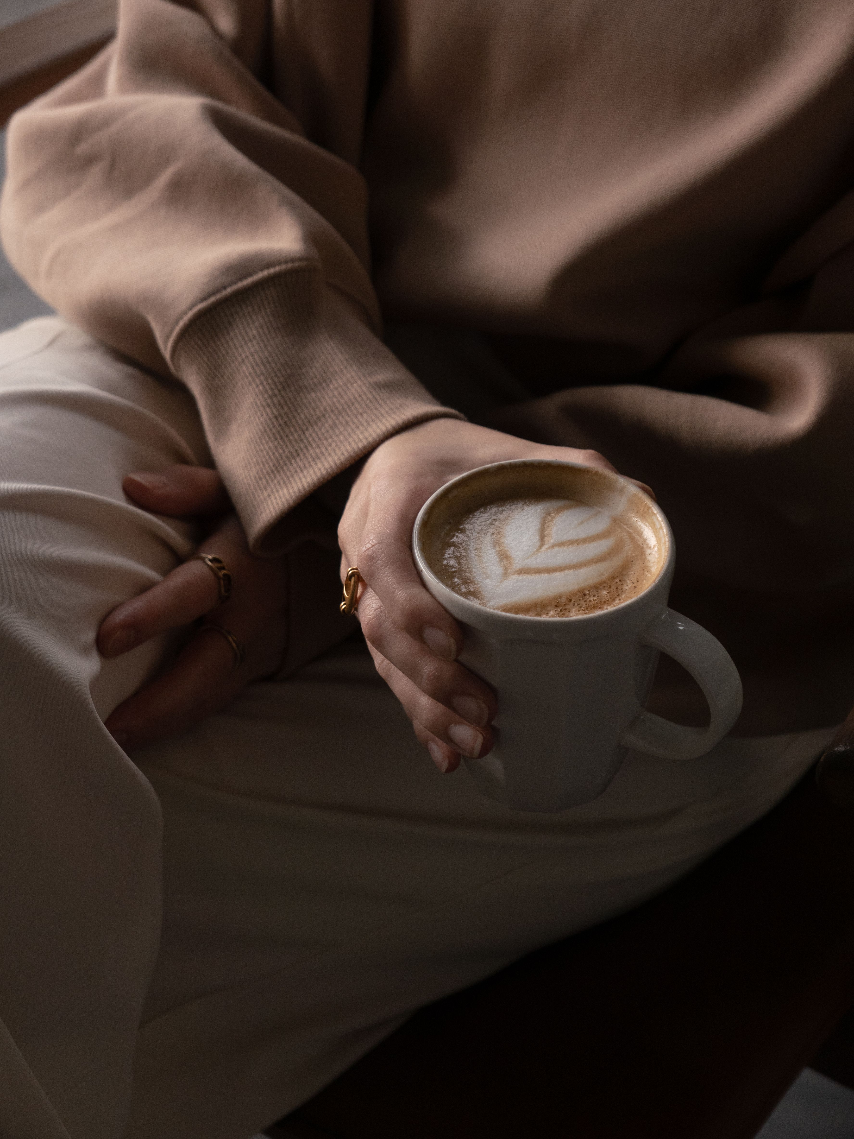 holding a cup of coffee