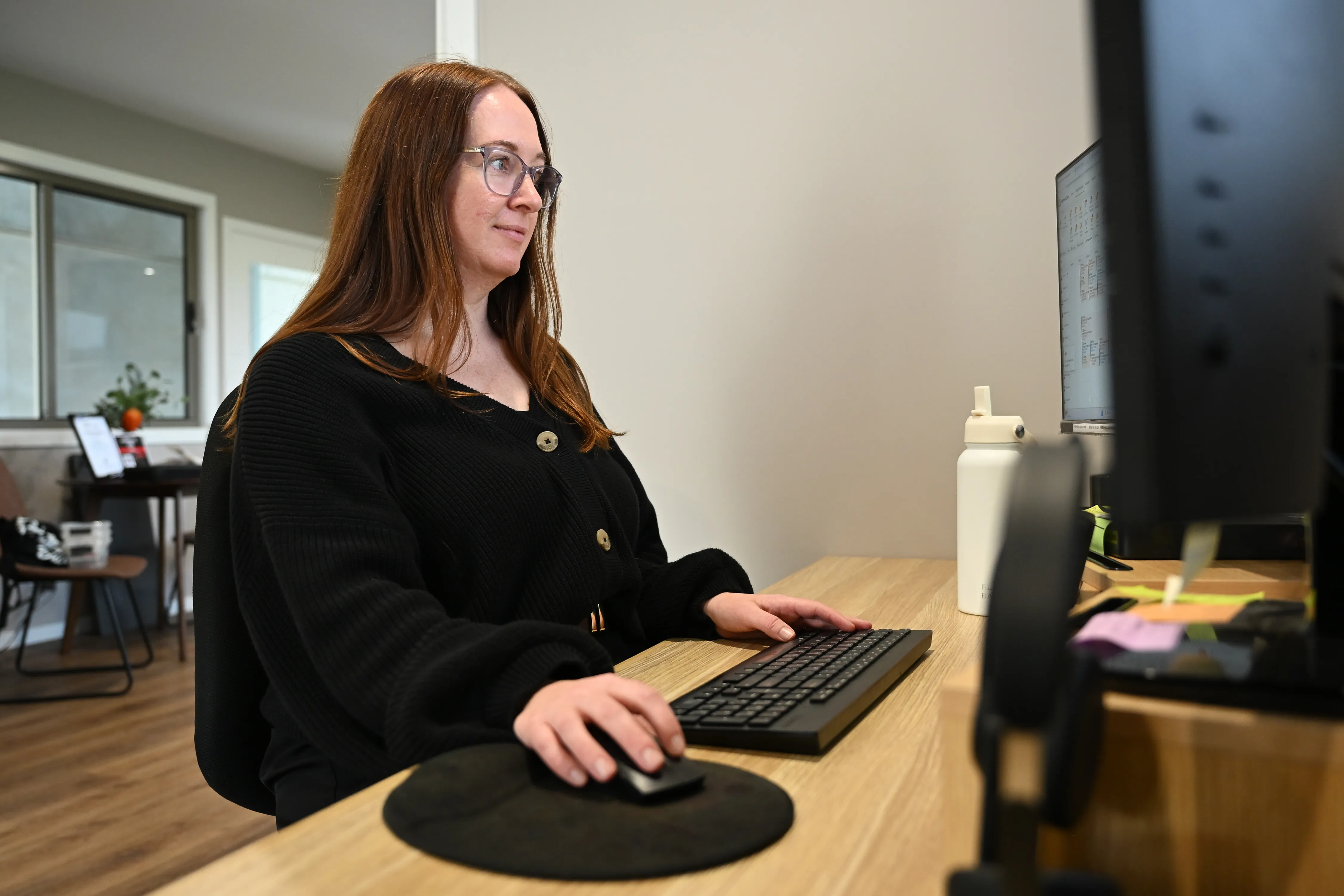 Bec, Business Manager at HomeSafeGV, at work in the office