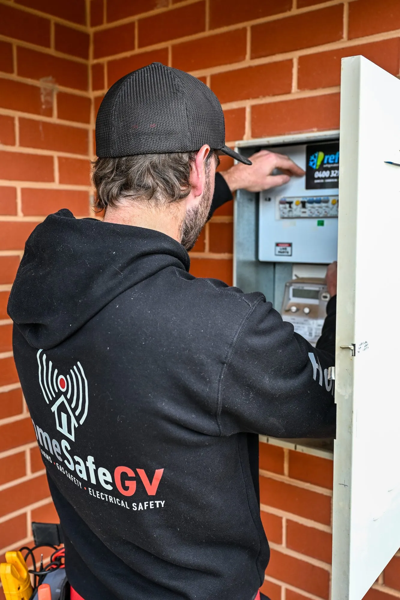 Alex, Senior Electrician at HomeSafeGV, testing a switchboard