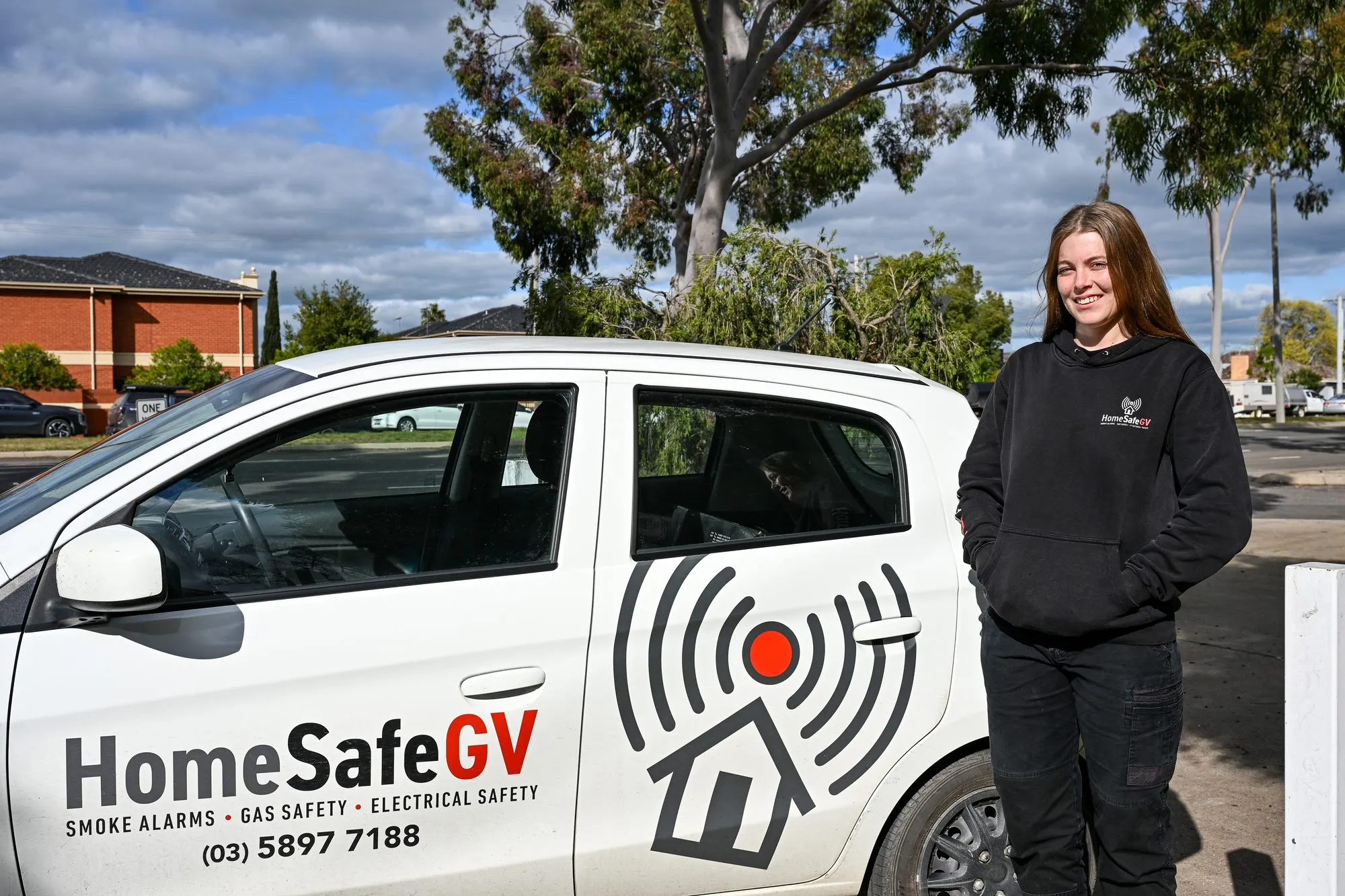 Jess, Smoke Alarm Technician at HomeSafeGV, arriving at a rental property