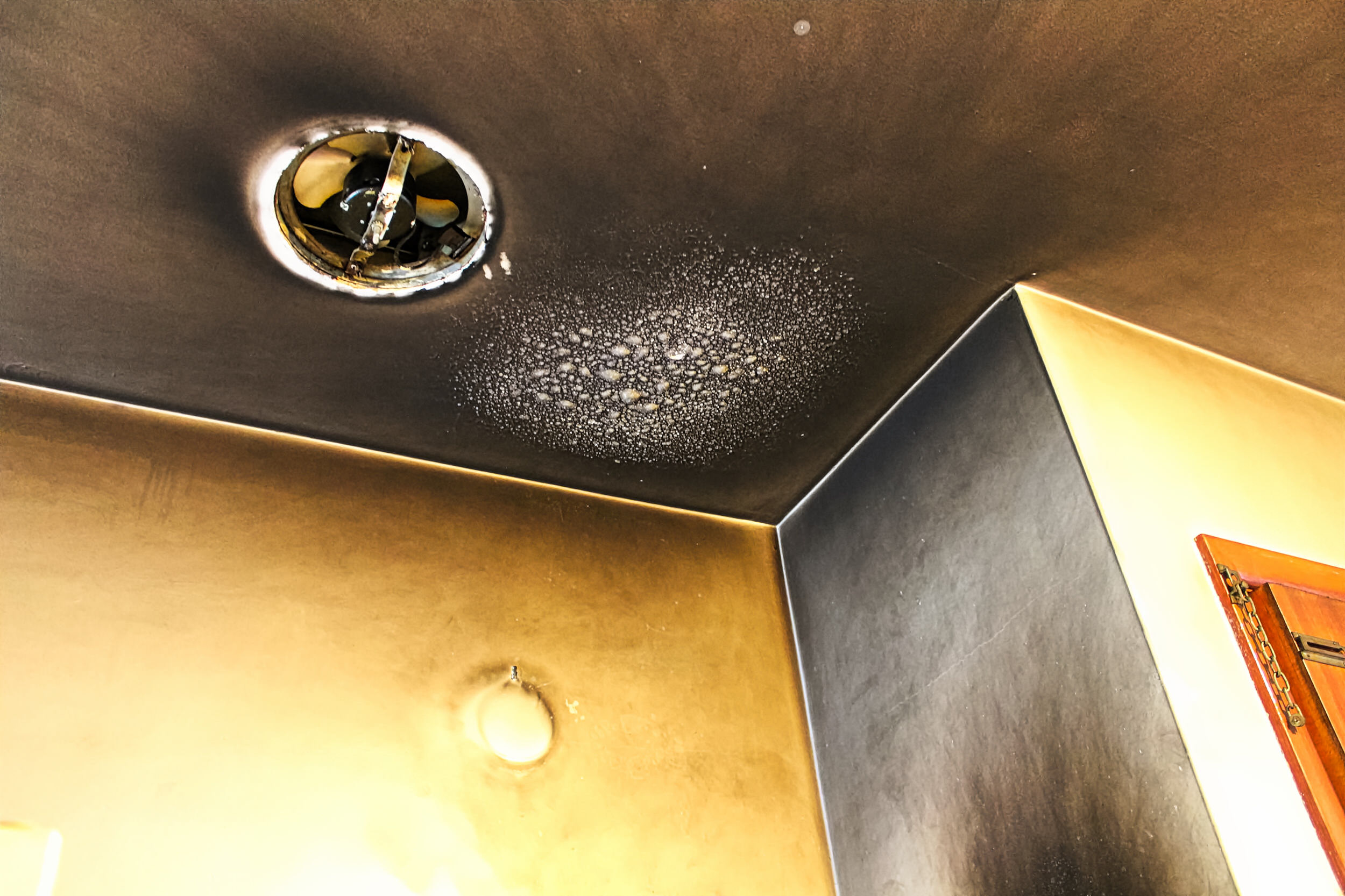 Blistered and smoke-blackened ceiling after a kitchen fire