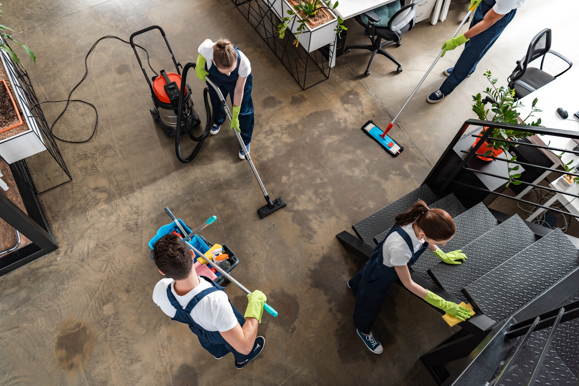 Cleaning team working through a modern office, viewed from above