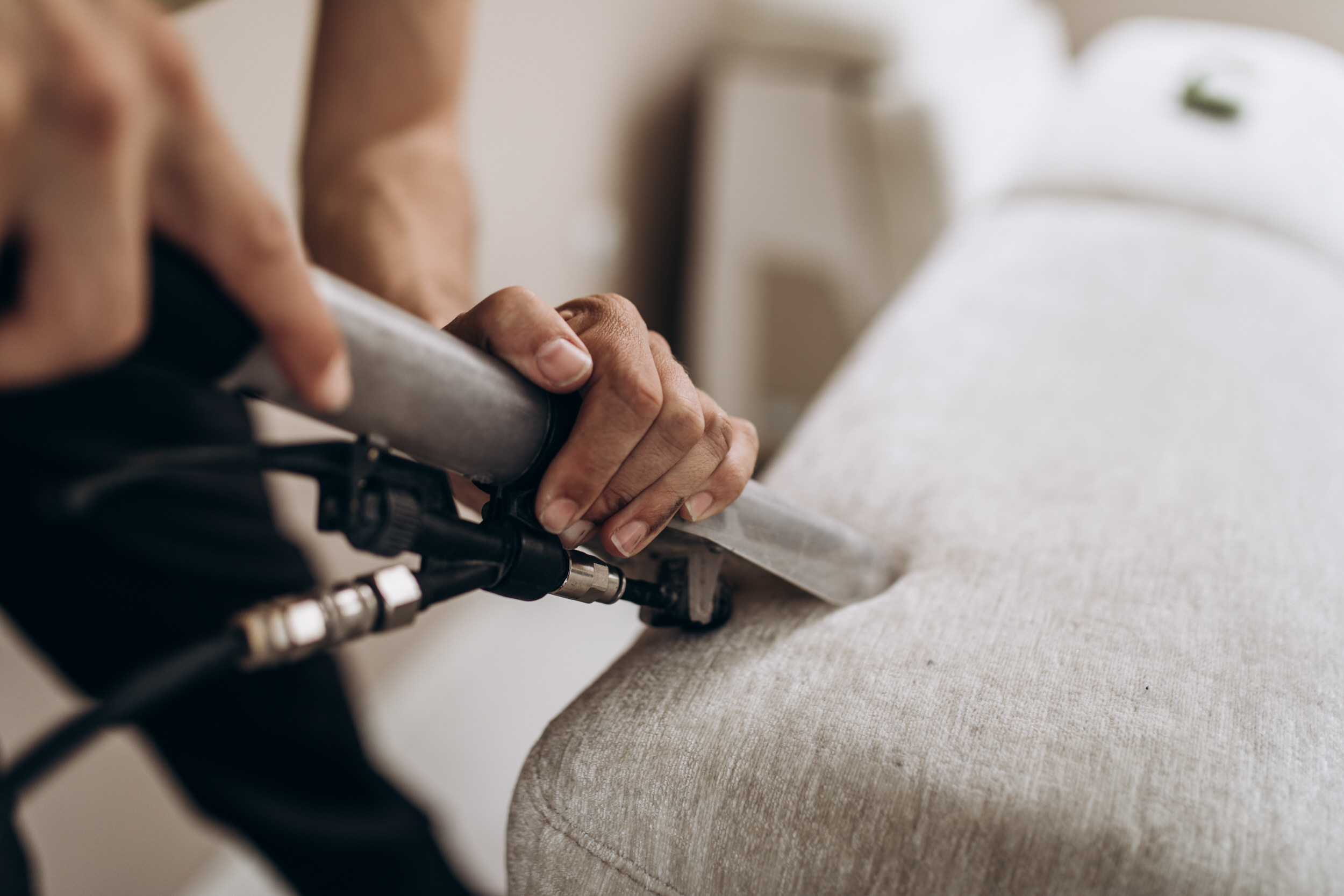 Deep cleaning a fabric sofa to remove dirt and stains