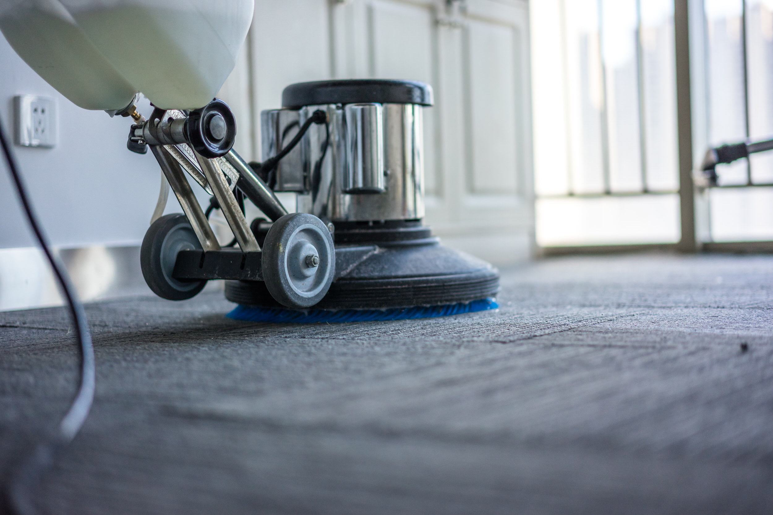 Cleaning a carpeted floor with a professional machine