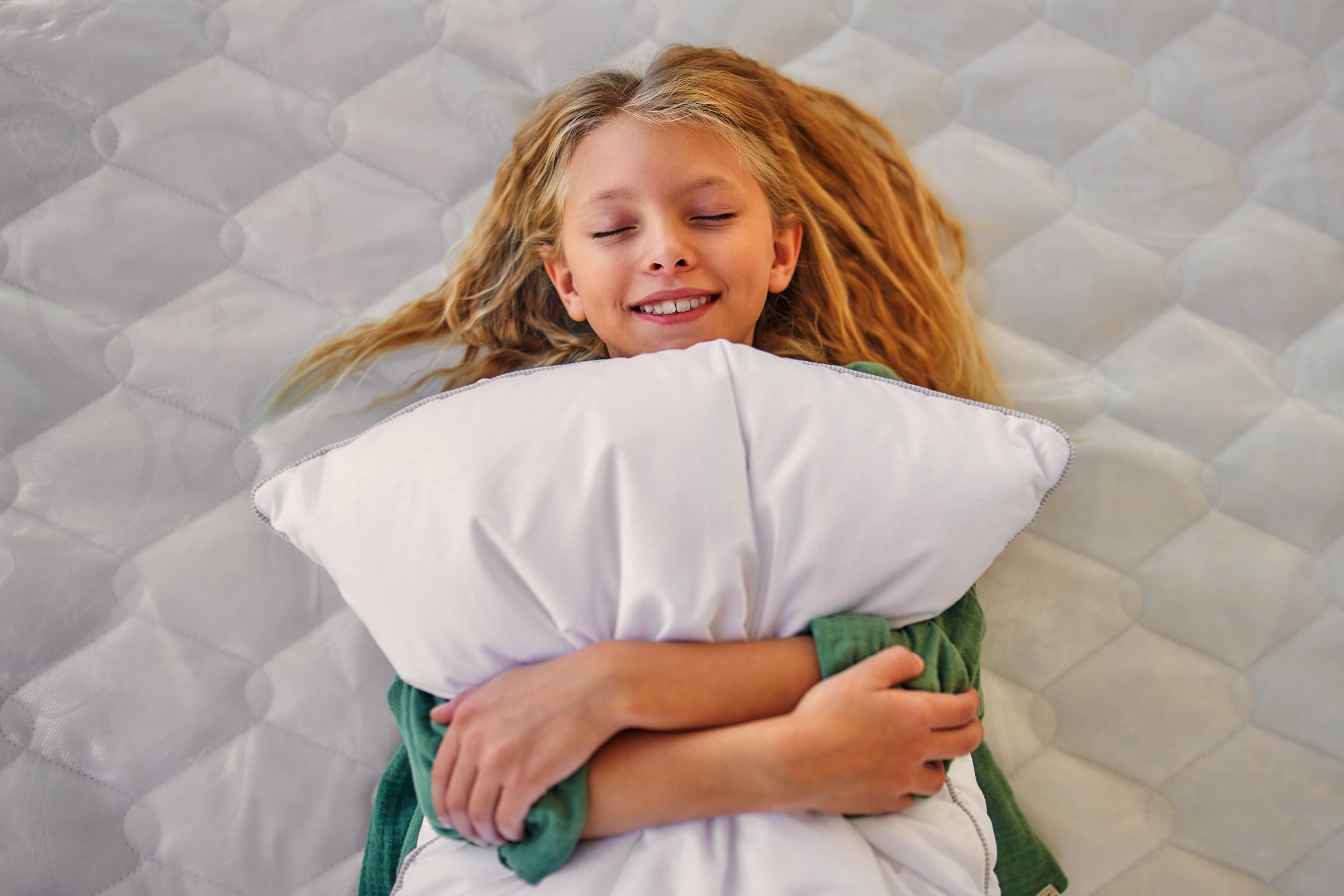 Clean mattress and pillows made up on a bed