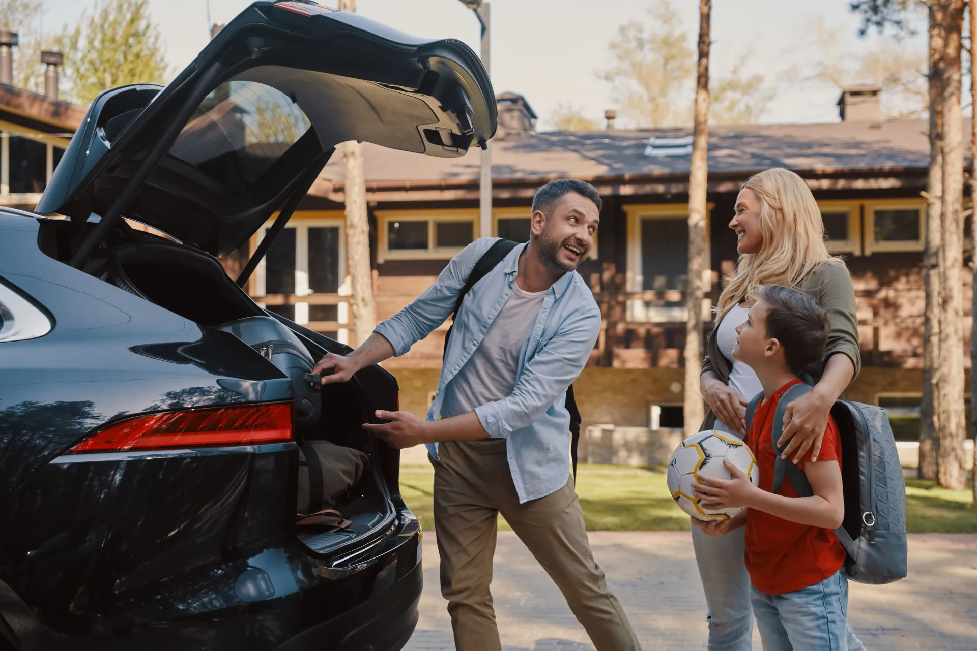 Family loading the car before setting off