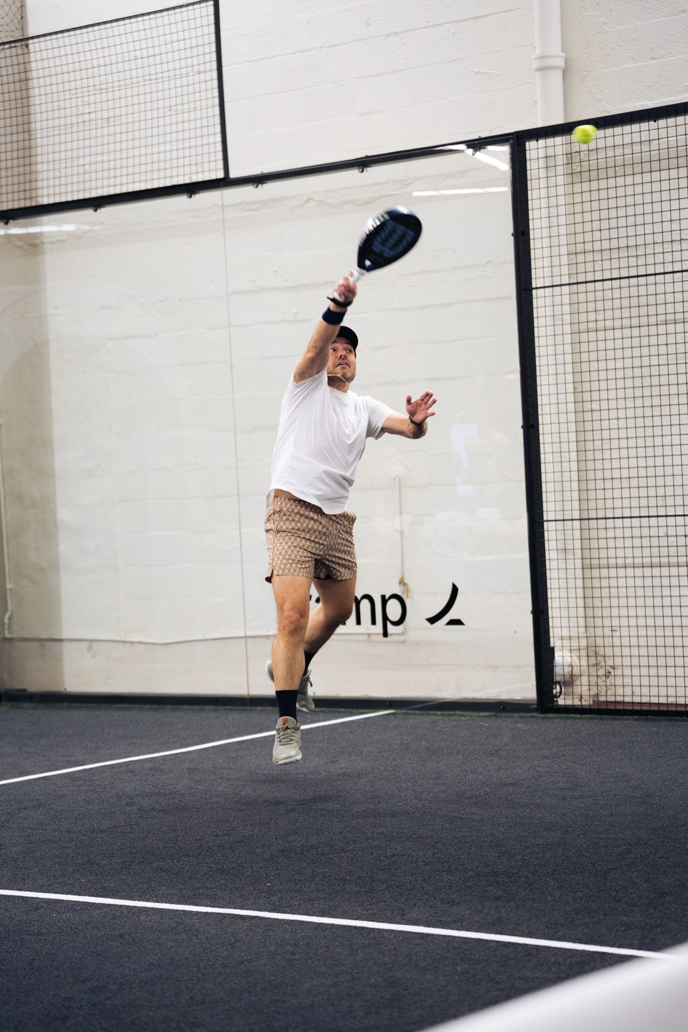 A Padner reaching for a serve