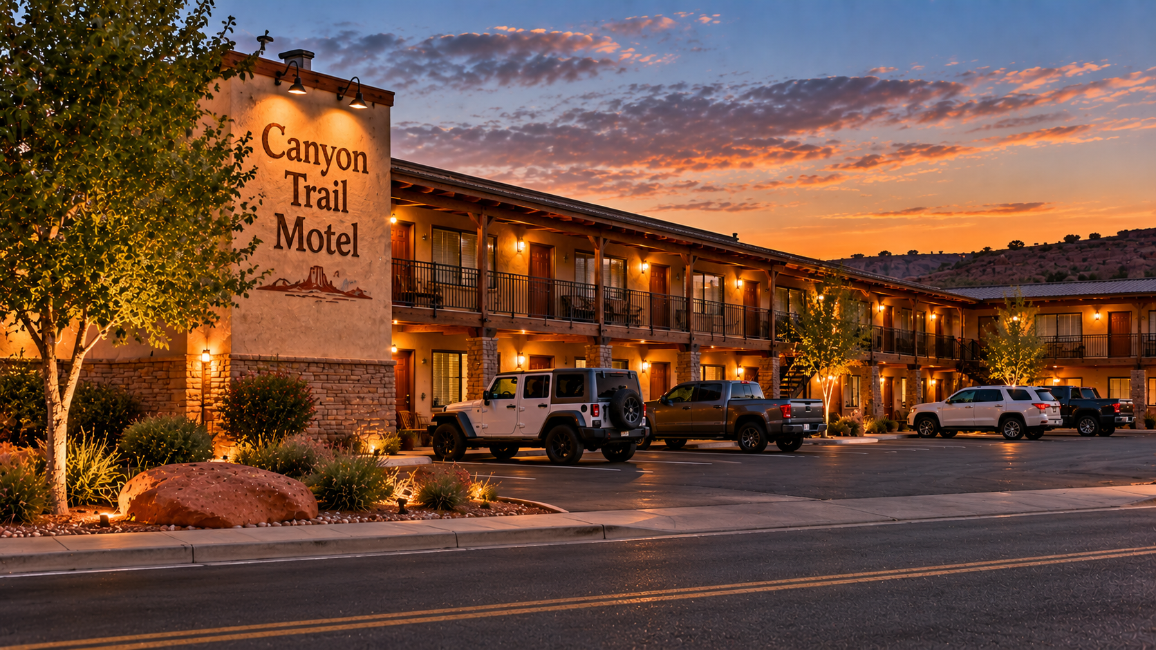 Canyon Trail Motel with Jeeps and trucks parked out front at dusk