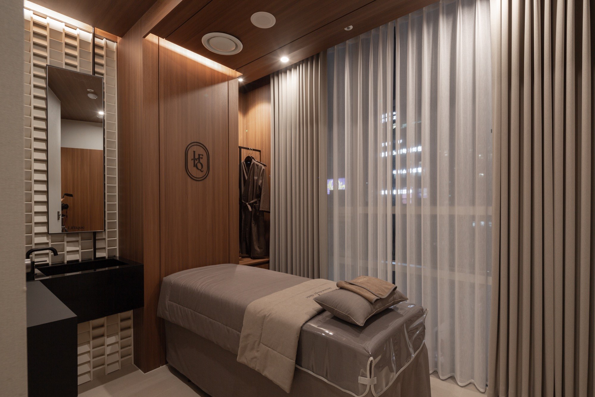 Private treatment room with a treatment bed at Liftique Dermatology Clinic