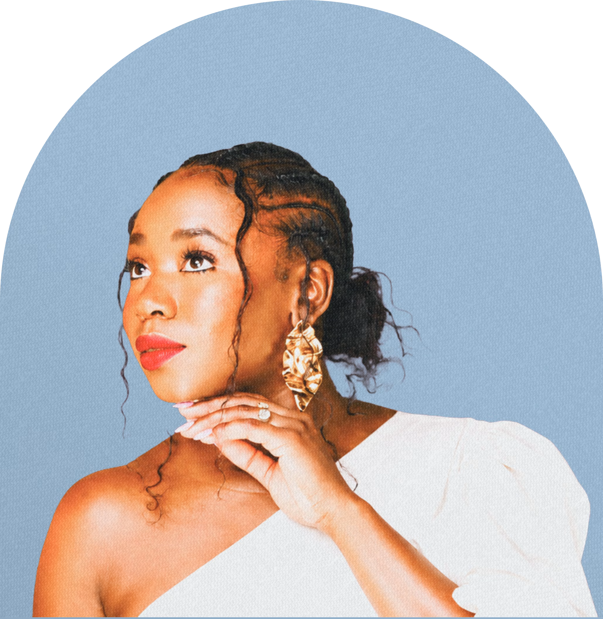 Portrait of a woman with braided hair and loose curls wearing a white off-shoulder top, large gold earrings, and red lipstick, looking thoughtfully upward with her hand gently touching her chin against a light blue background.