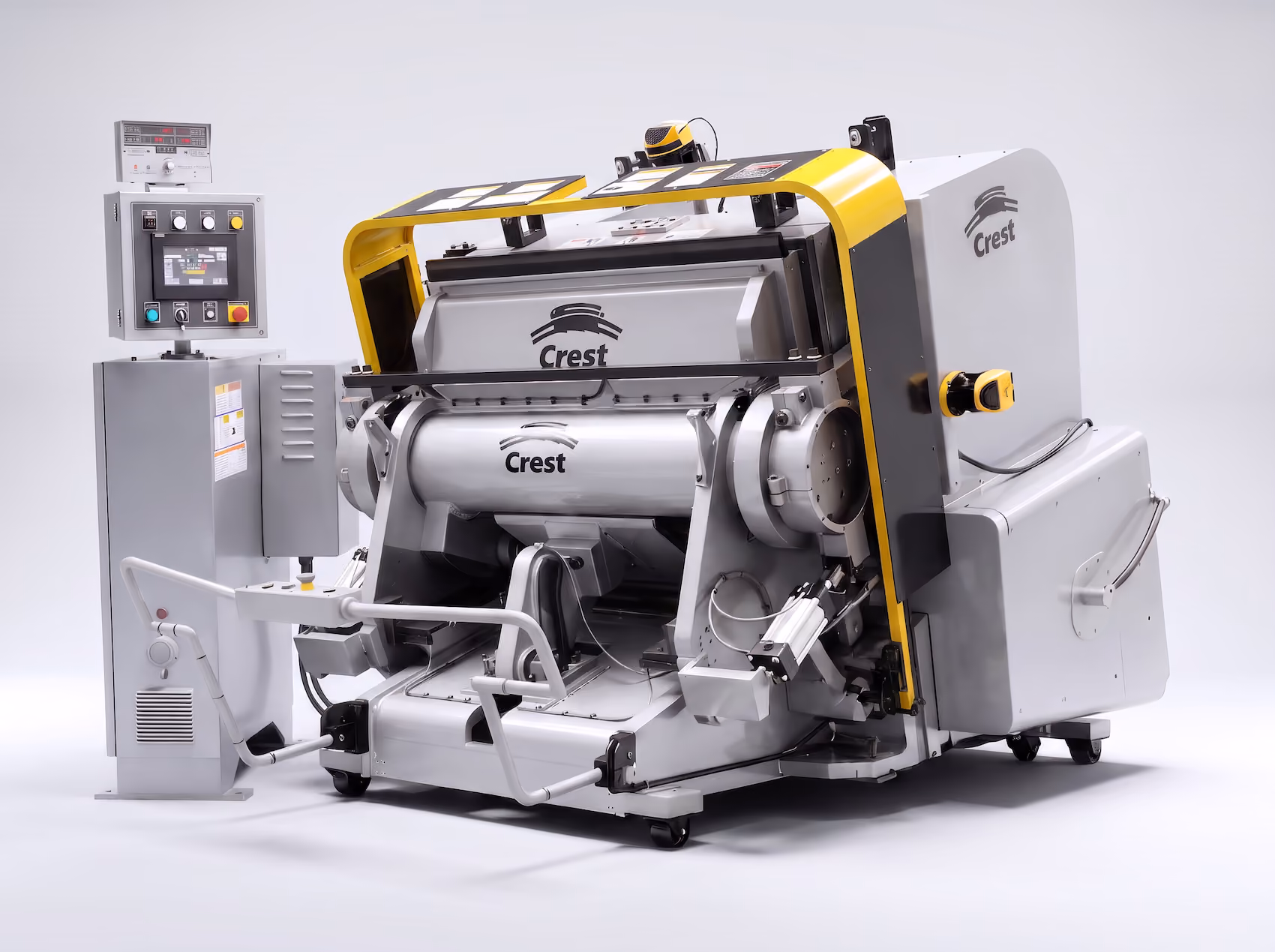 Industrial machine with Crest branding, featuring a large silver cylindrical component mounted on a yellow and gray frame, with an adjacent control panel with multiple buttons and a display screen.