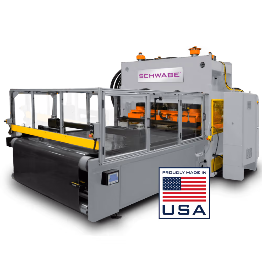 Large industrial machine labeled SCHWABE with enclosed protective glass panels and safety features, featuring orange mechanical components and a display screen, with a 'Proudly Made in USA' label and American flag.