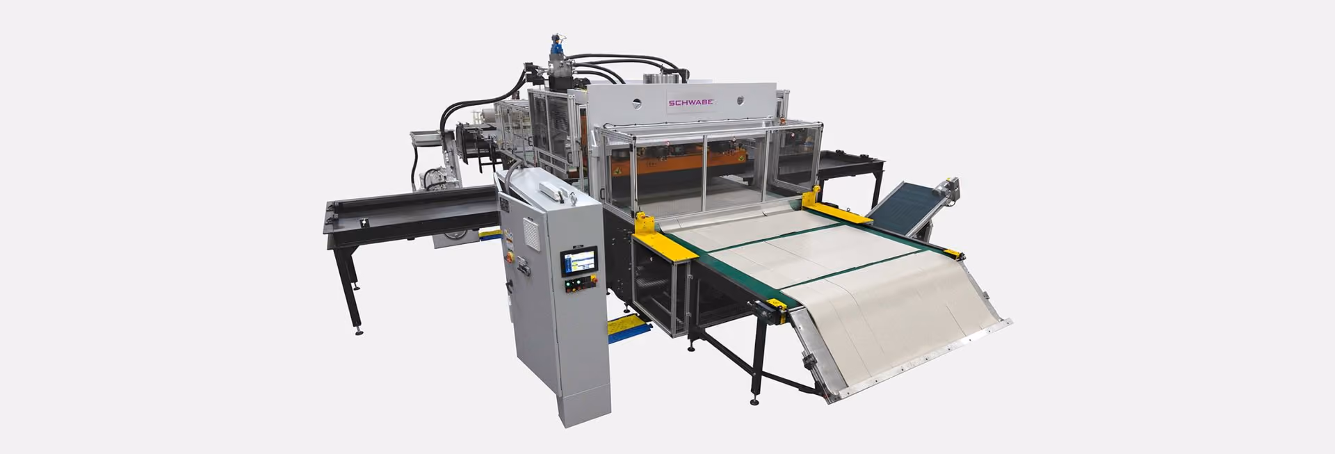 Industrial cutting machine with conveyor belts, control panel, and protective transparent cover designed for automated cutting or processing tasks in manufacturing.