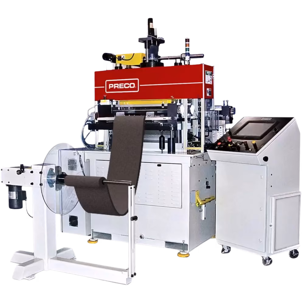 Industrial machine labeled PRECO with a roll of dark material feeding into it and a separate white control unit with a display screen and control buttons on the right side, set against a white background.