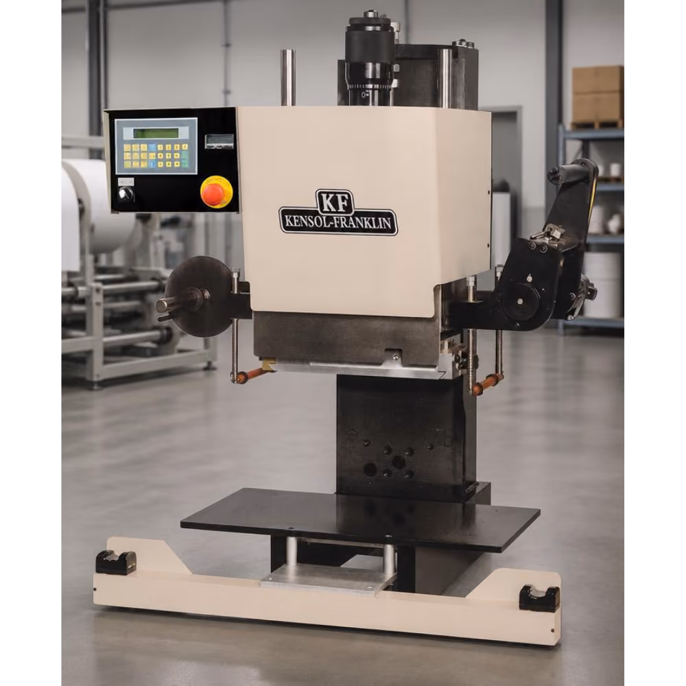 Industrial Kensol-Franklin machine with a digital control panel featuring a keypad and emergency stop button, used in a manufacturing setting.