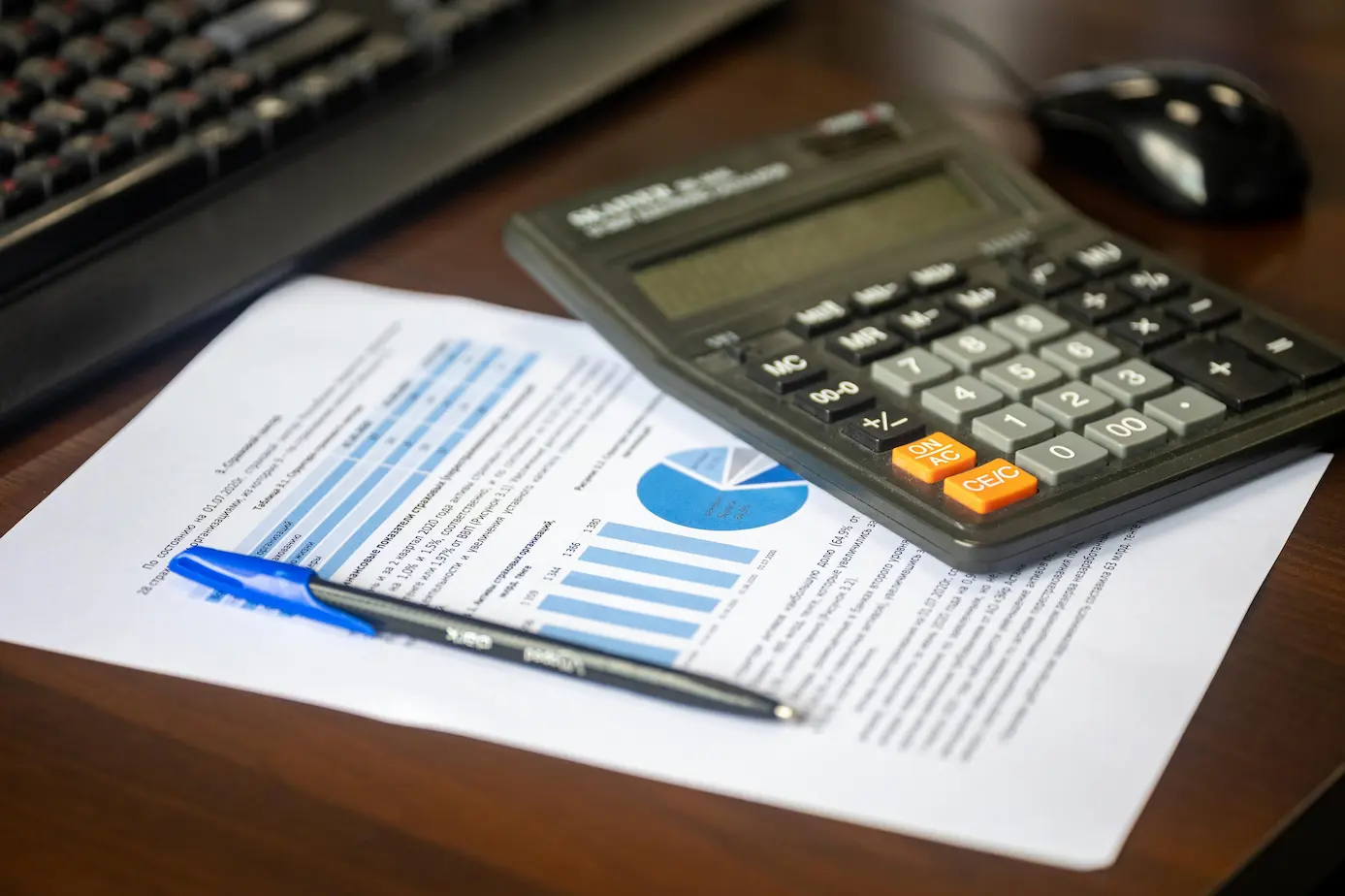 Bureau avec calculatrice, rapport financier et stylo