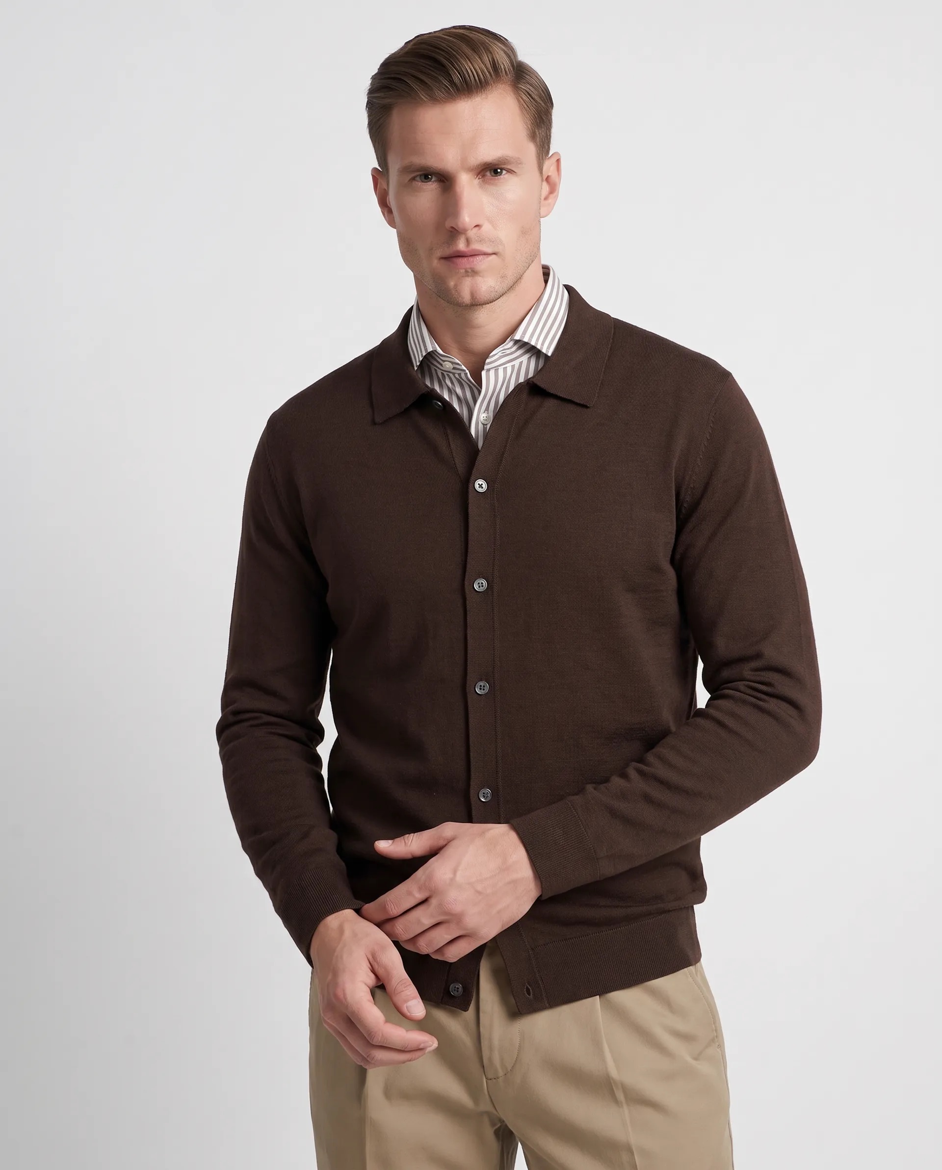 Een tweede merkmodel in een crèmekleurig vest en grijze pantalon