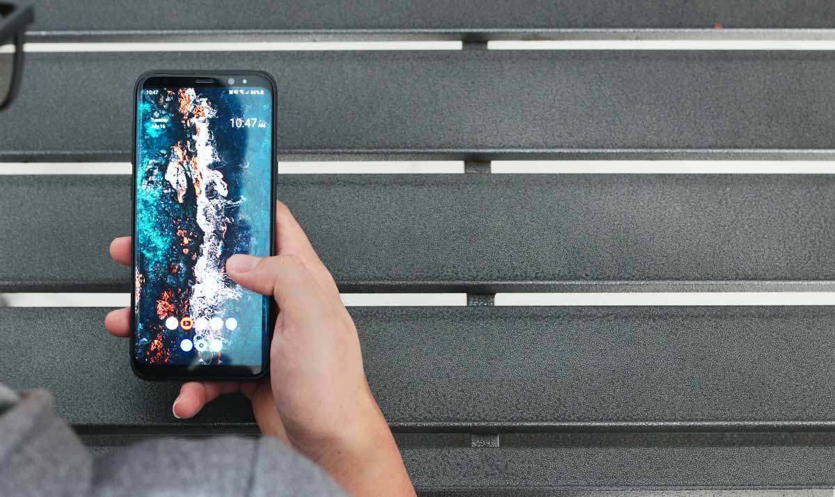 Man in glasses using an android phone