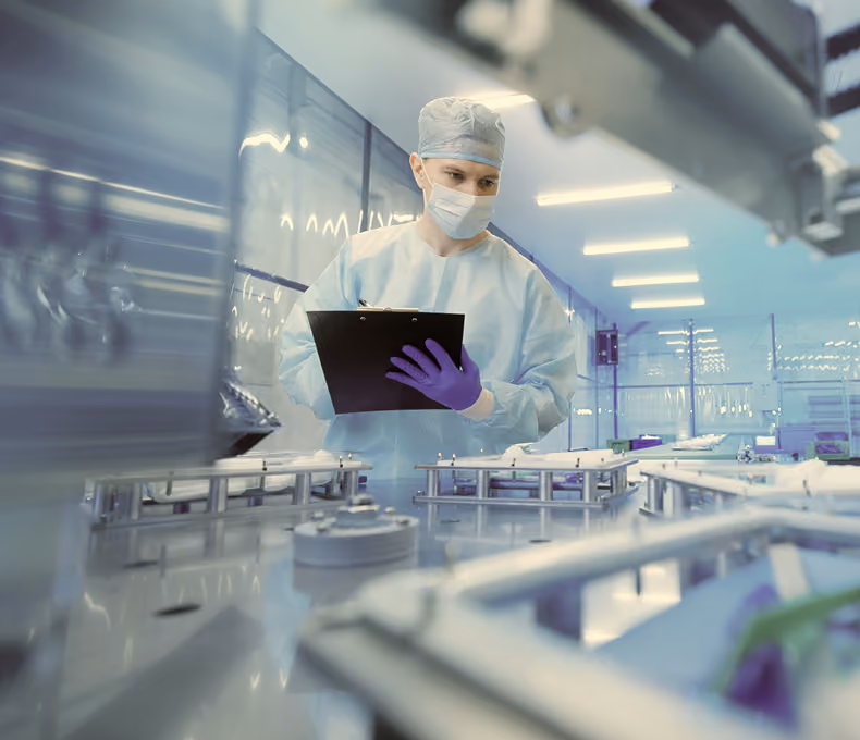 Pharmaceutical manufacturing team reviewing production data on the shop floor