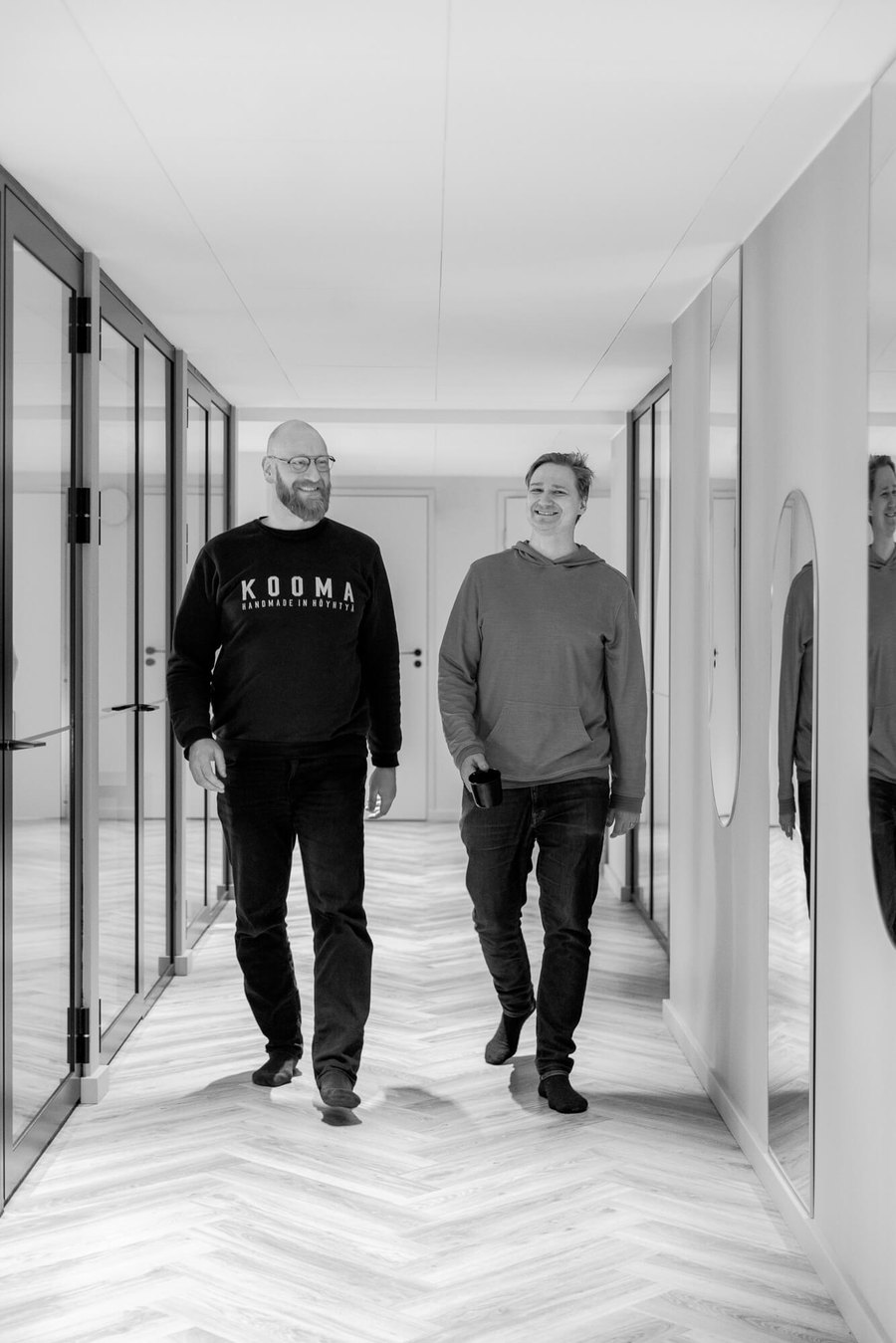 Two Brightly colleagues walking through the Helsinki office