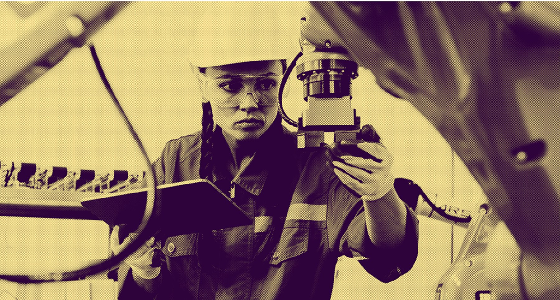 Technician inspecting an industrial robot arm