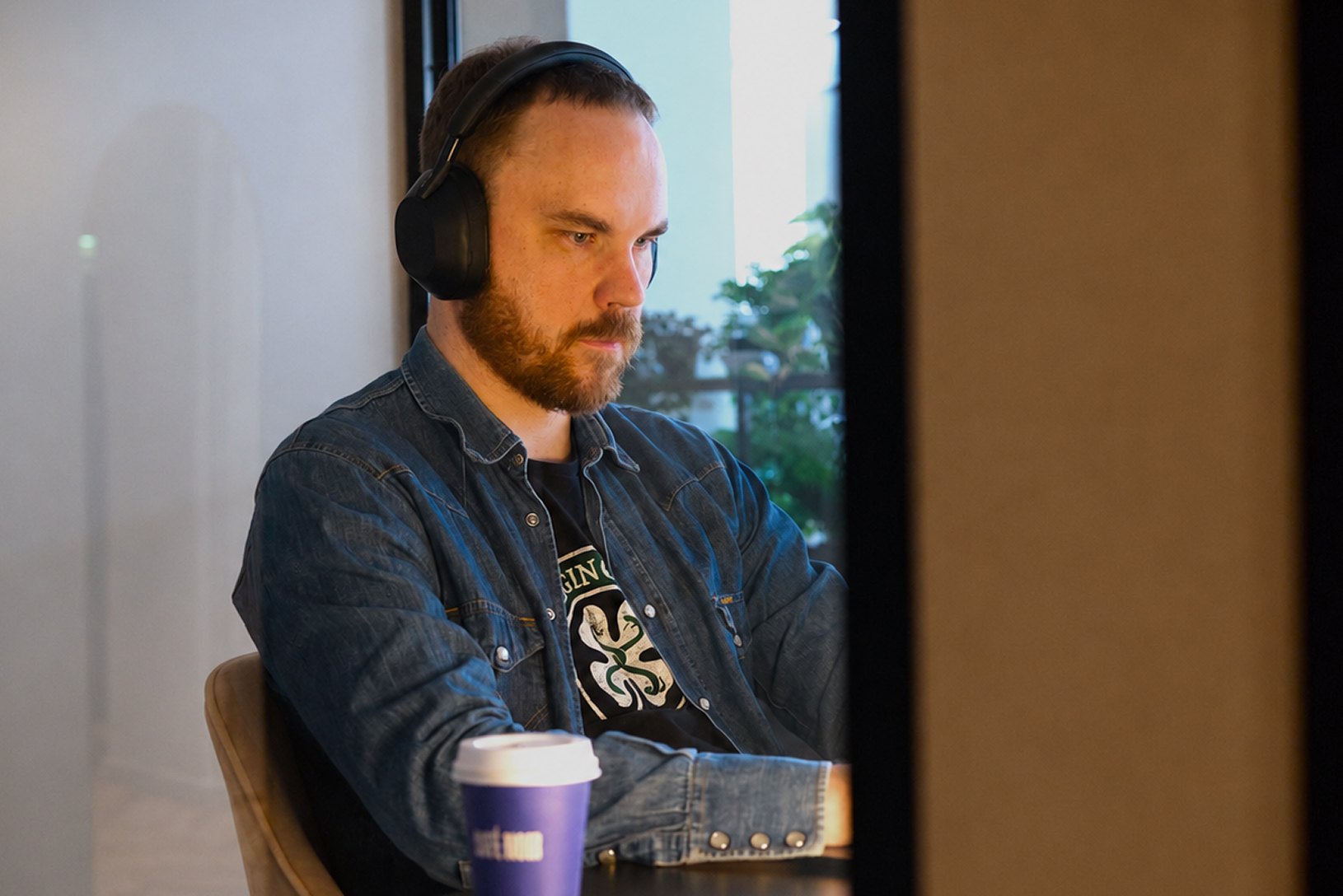 Engineer with headphones working at a laptop