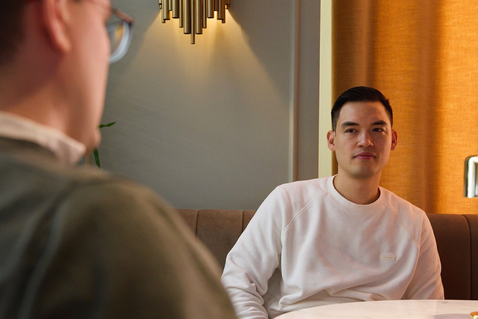 Two people in conversation across a table