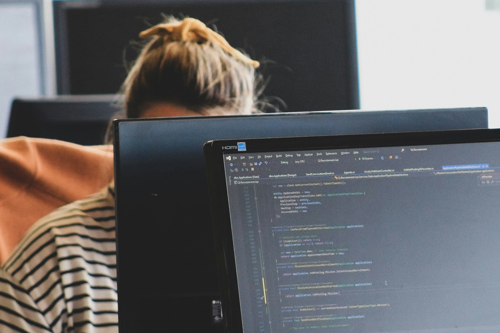 Developer writing code on a laptop