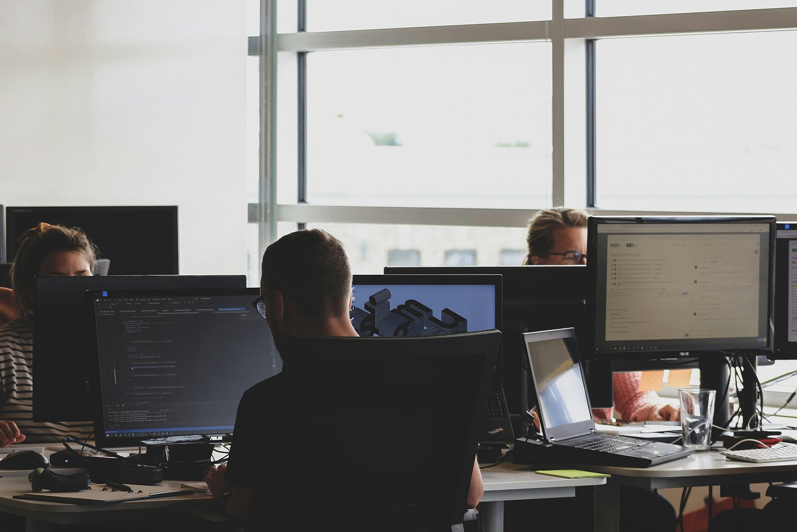 Engineers at workstations in an open office