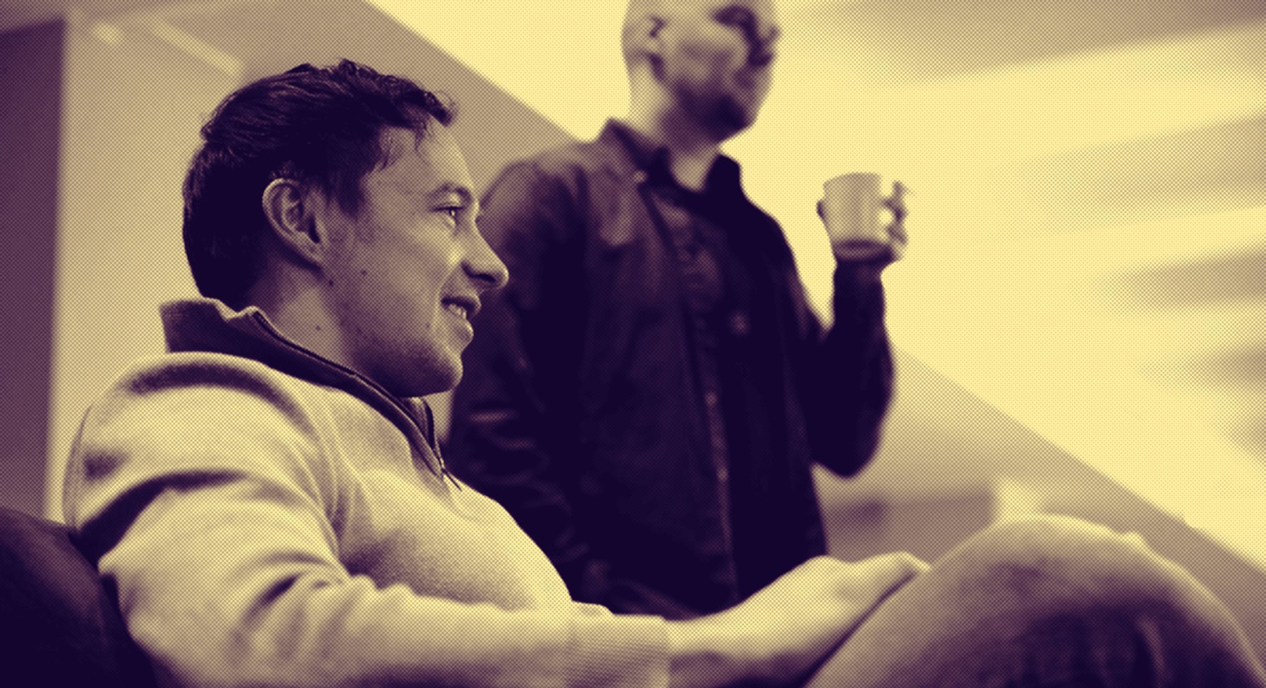 Two colleagues talking over coffee