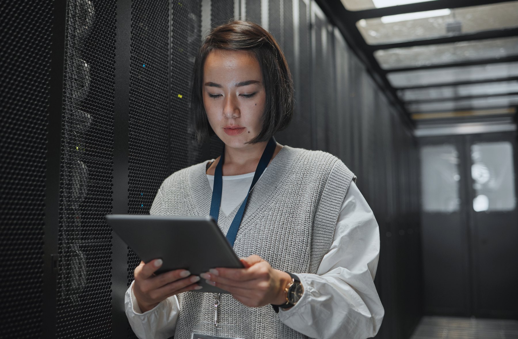 Engineer with a tablet in a server room