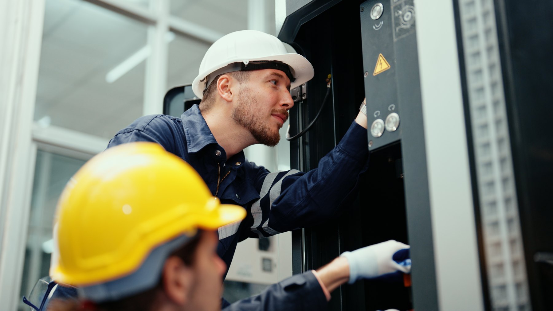 Technicians servicing an industrial machine
