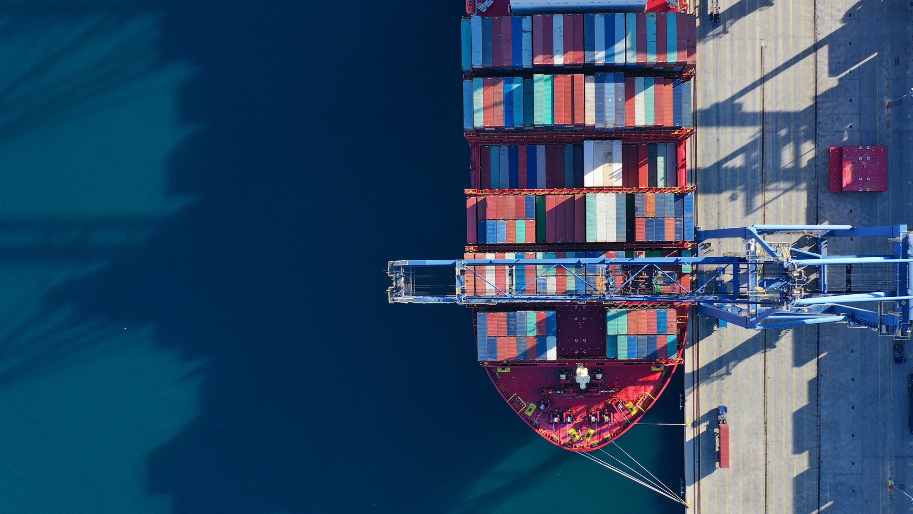 Container ship being loaded at a port, seen from above