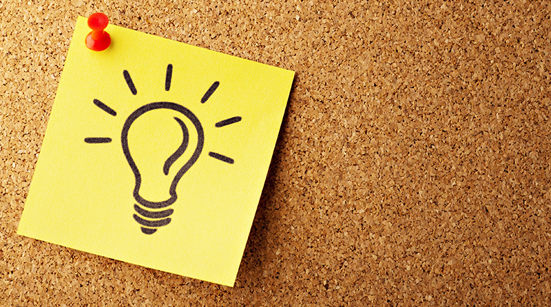 A post-it note on a bulletin board with a light bulb on it representing api risk