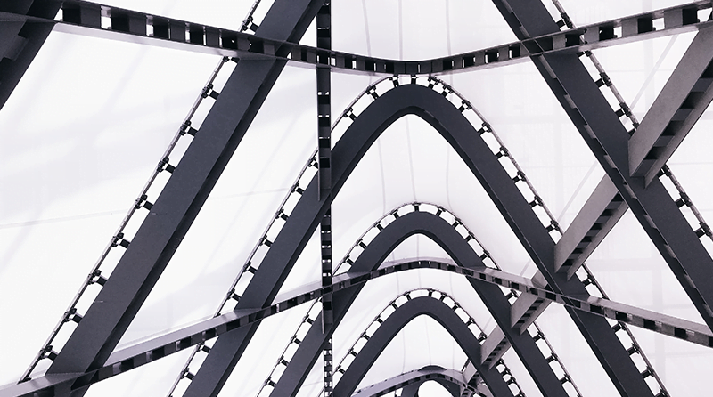 Looking up at the trellises of a bridge representing API security and OWASP