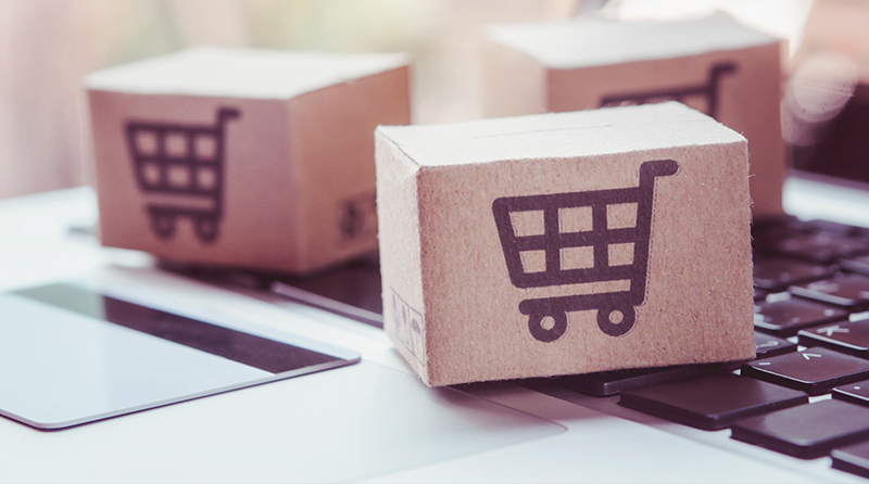 Wooden blocks with shopping carts on them representing a shopping bot attack