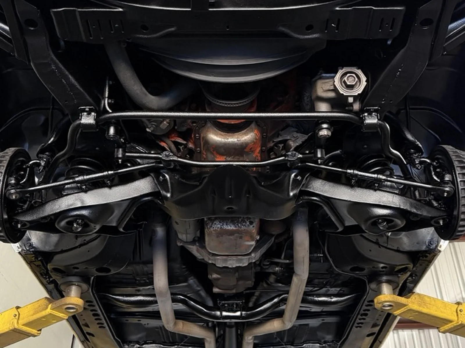 Dinitrol 4941 black wax undercoating applied to a vehicle underside